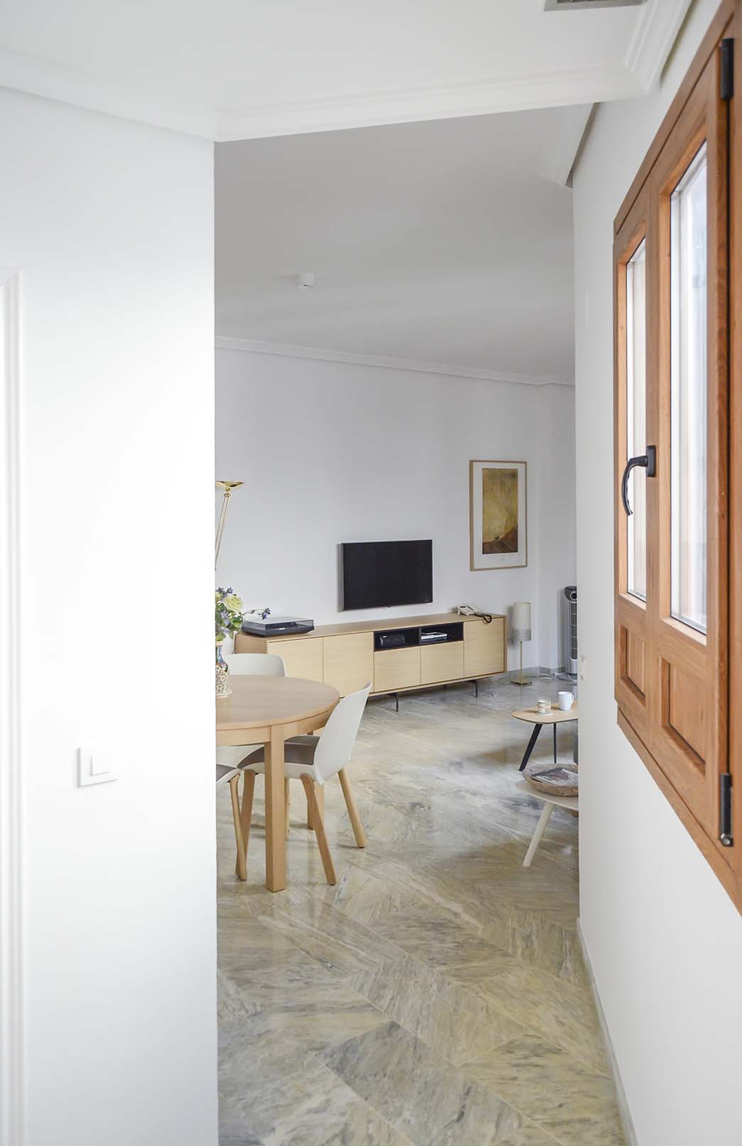 Las paredes y las puertas se han pintado en blanco cálido (RAL 9010), para subrayar la personalidad del mobiliario, y mejorar la luminosidad de un salón interior. La iluminación se potenció mediante unos miniplafones ópticos que subrayan la discreción de la intervención.